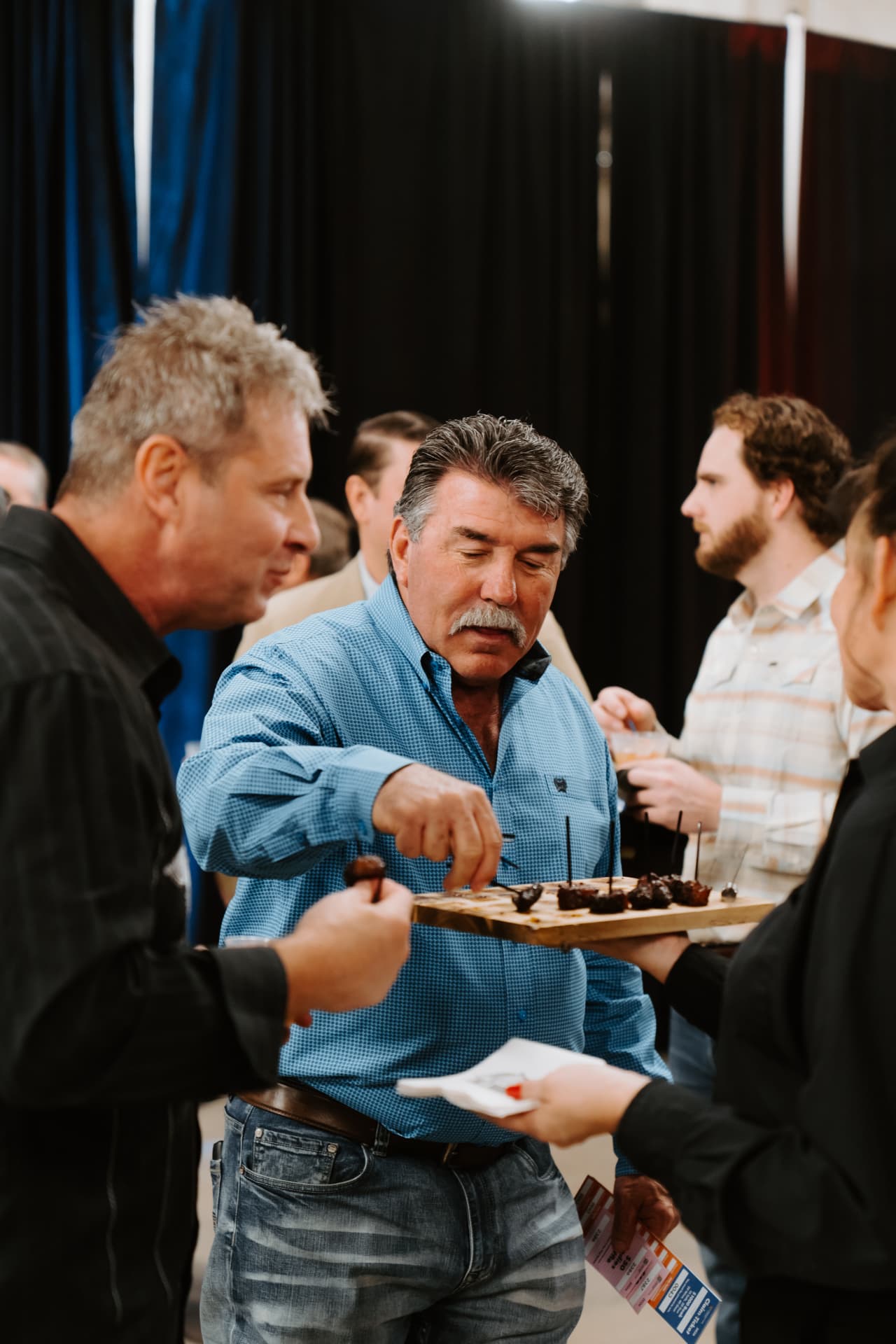 Guests sampling passed bites at a club event