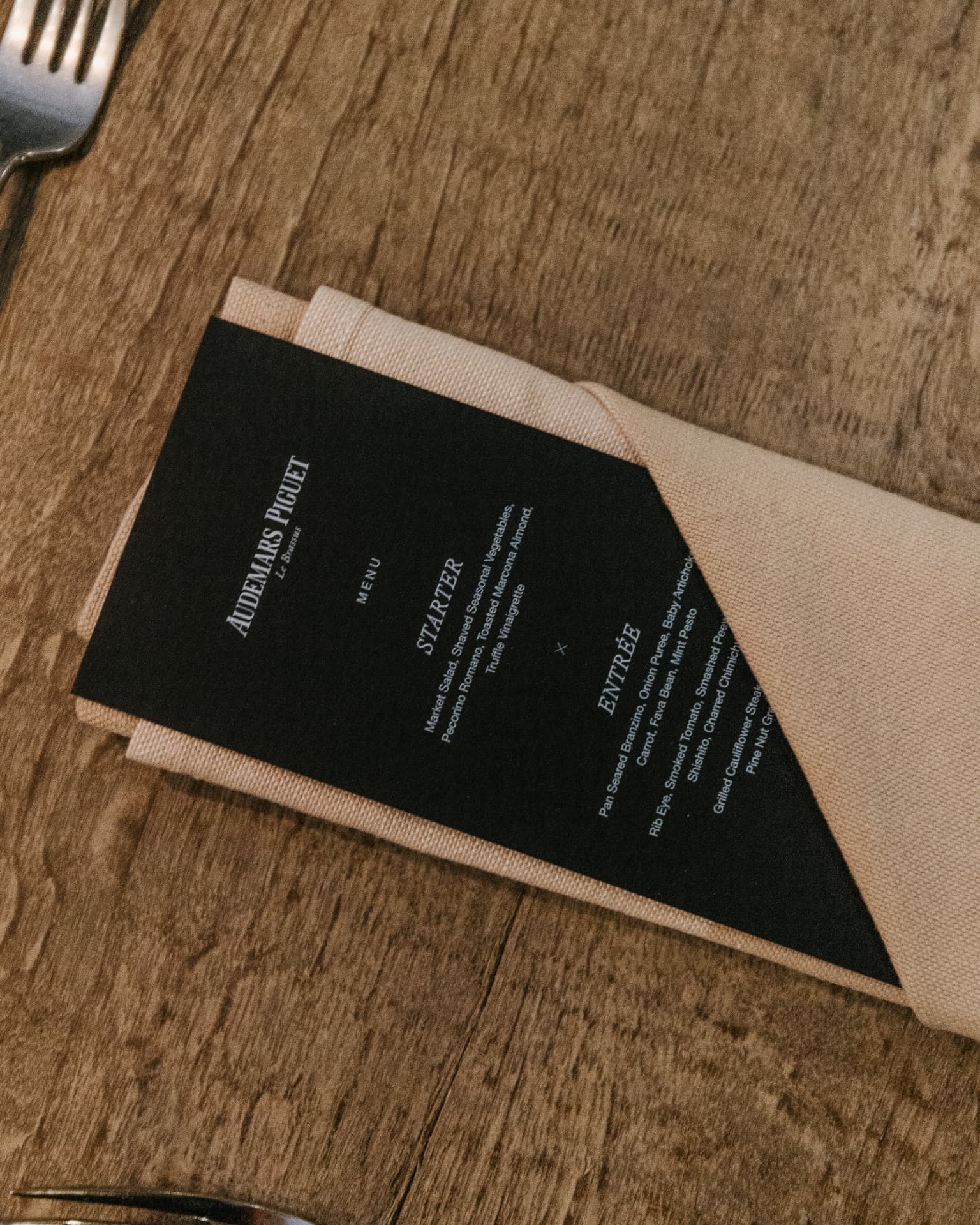 Audemars Piguet dinner menu on linen napkin