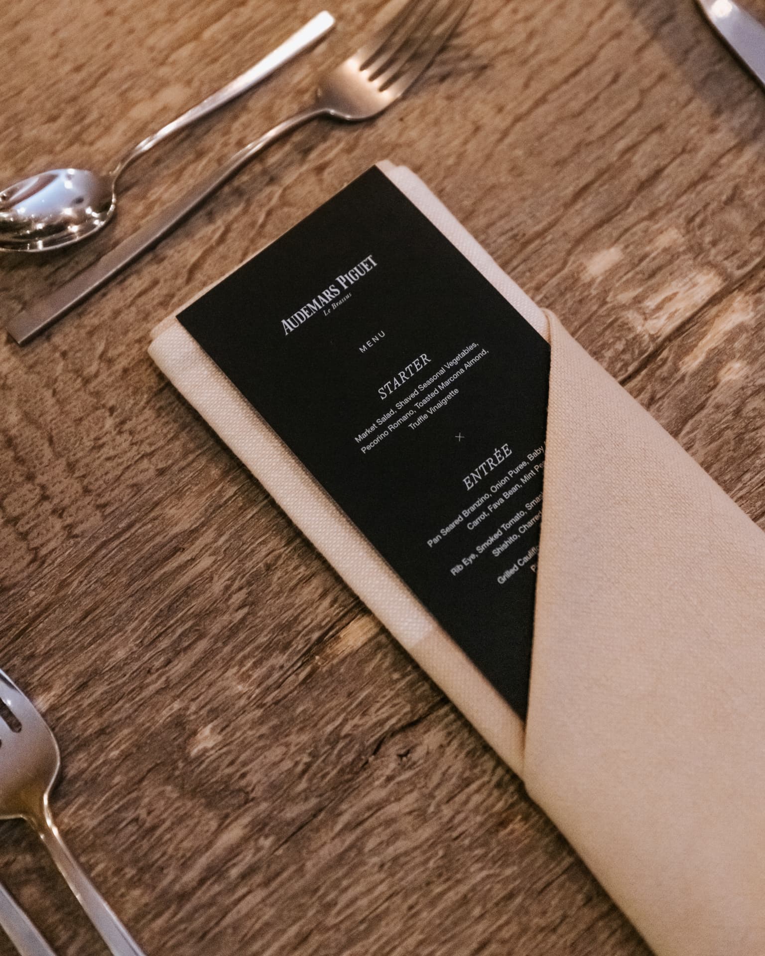 Audemars Piguet menu card on a linen napkin