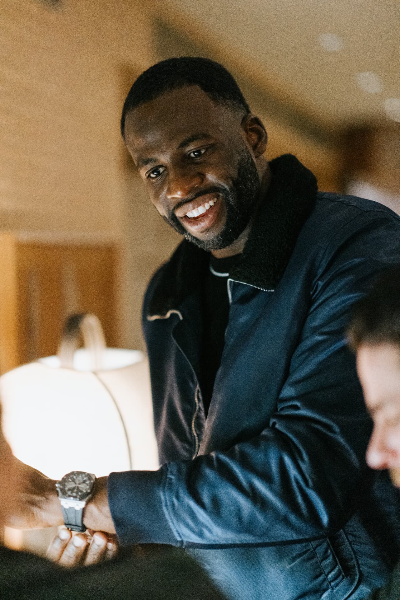 Guest smiling while trying on a watch