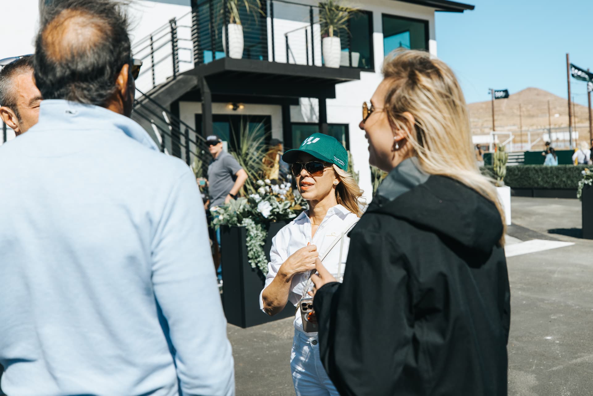 Guests talking outside a raceway VIP suite