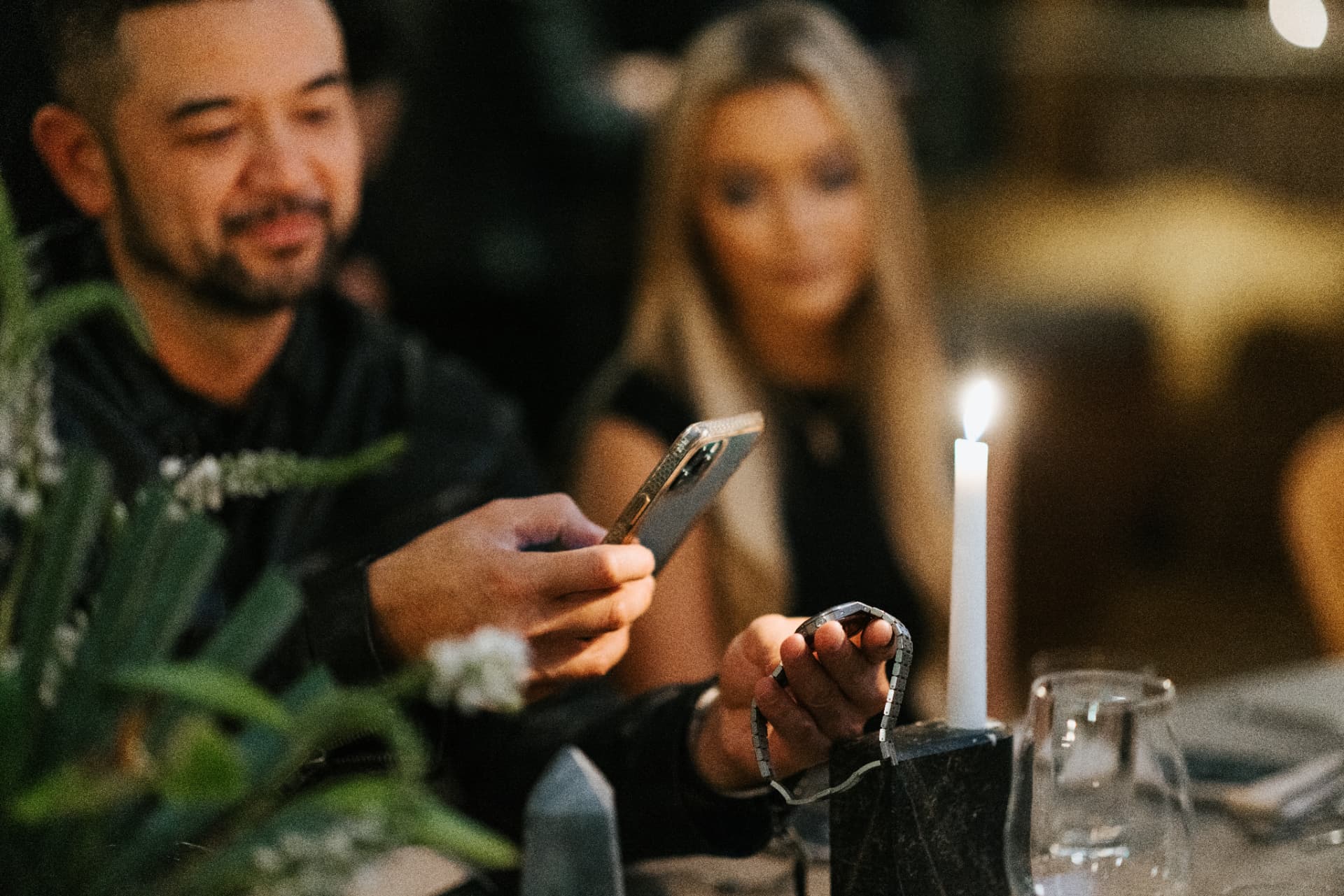 Guest photographing a watch by candlelight