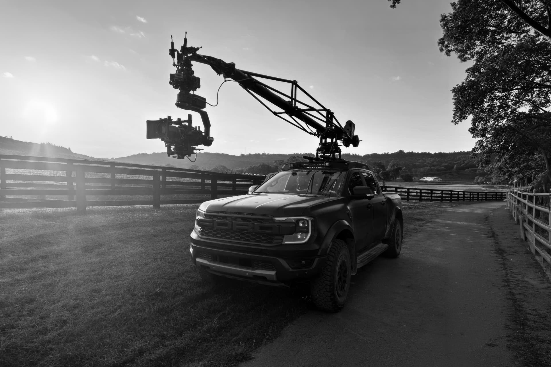 The Live More Media Group camera truck carrying a crane arm at sunrise