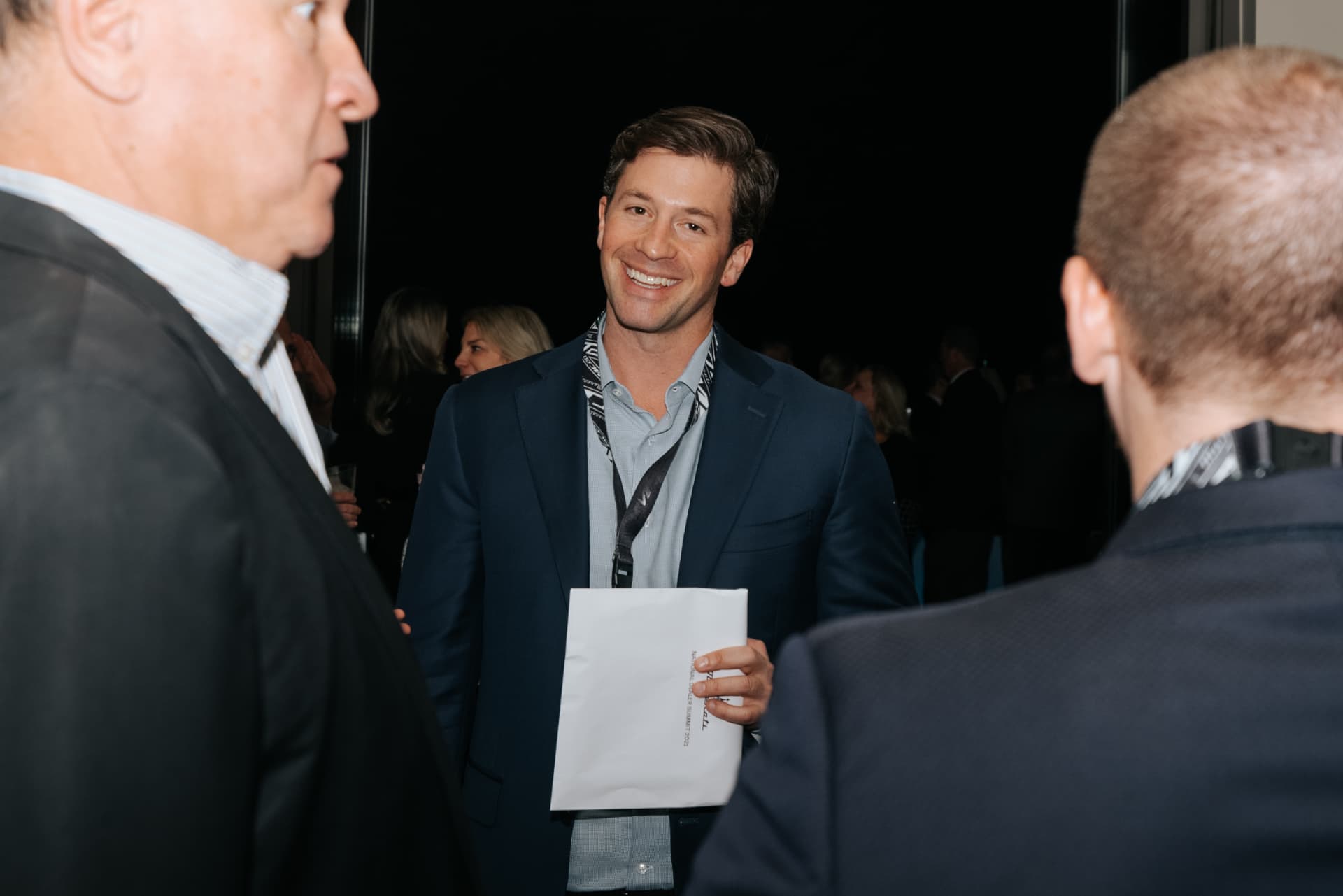 Attendee greeting guests at a dealer summit