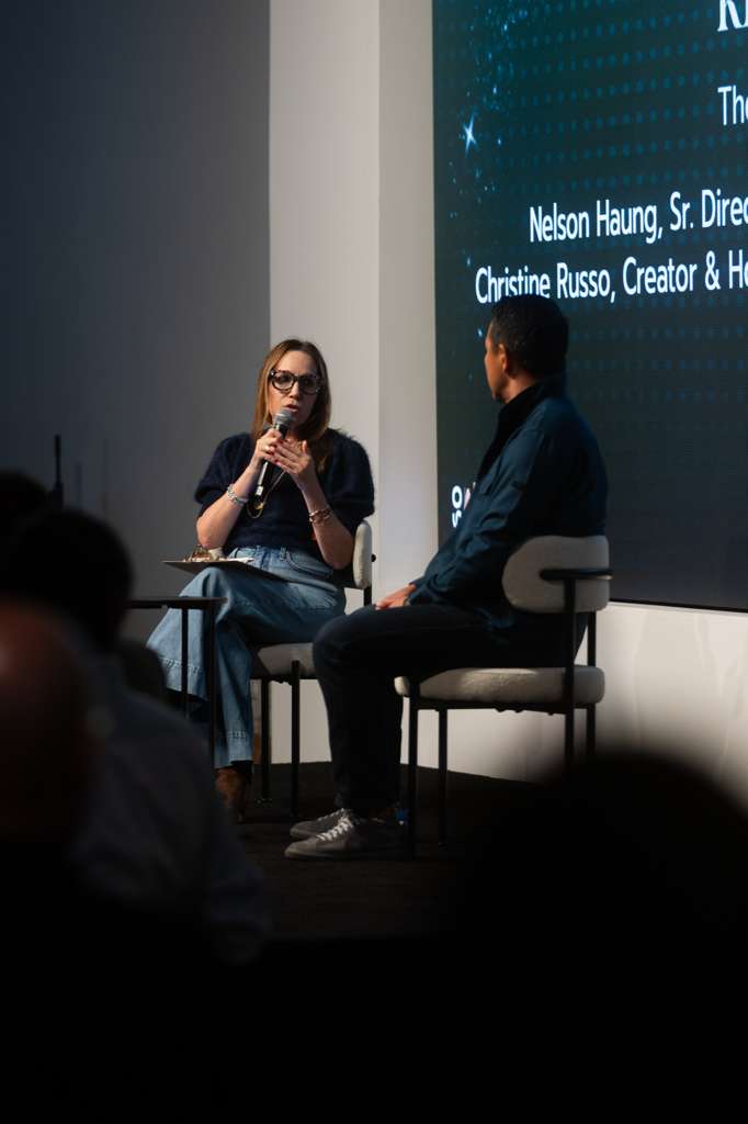 Host interviewing a guest during a forum panel