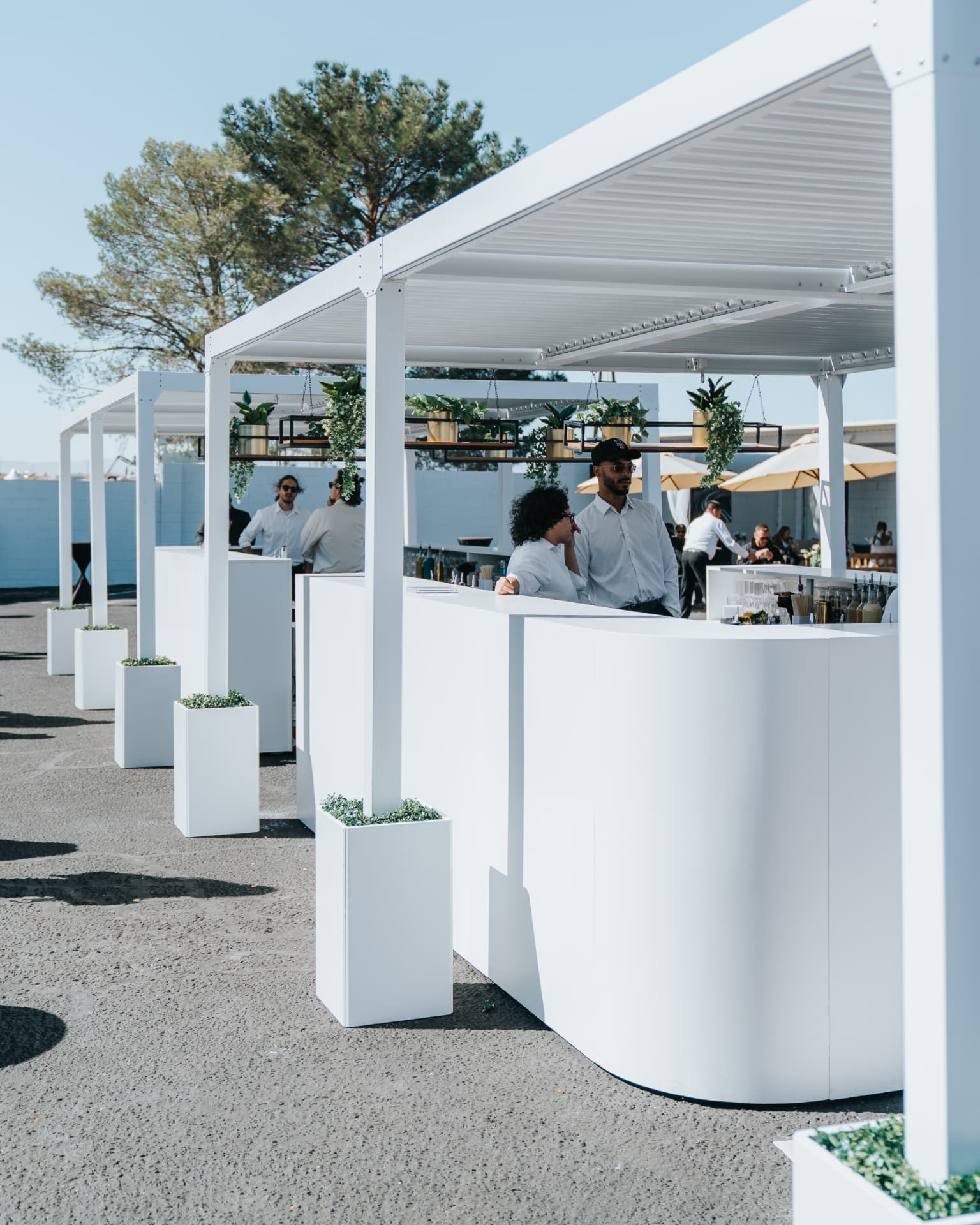 White outdoor bar builds at a trackside activation