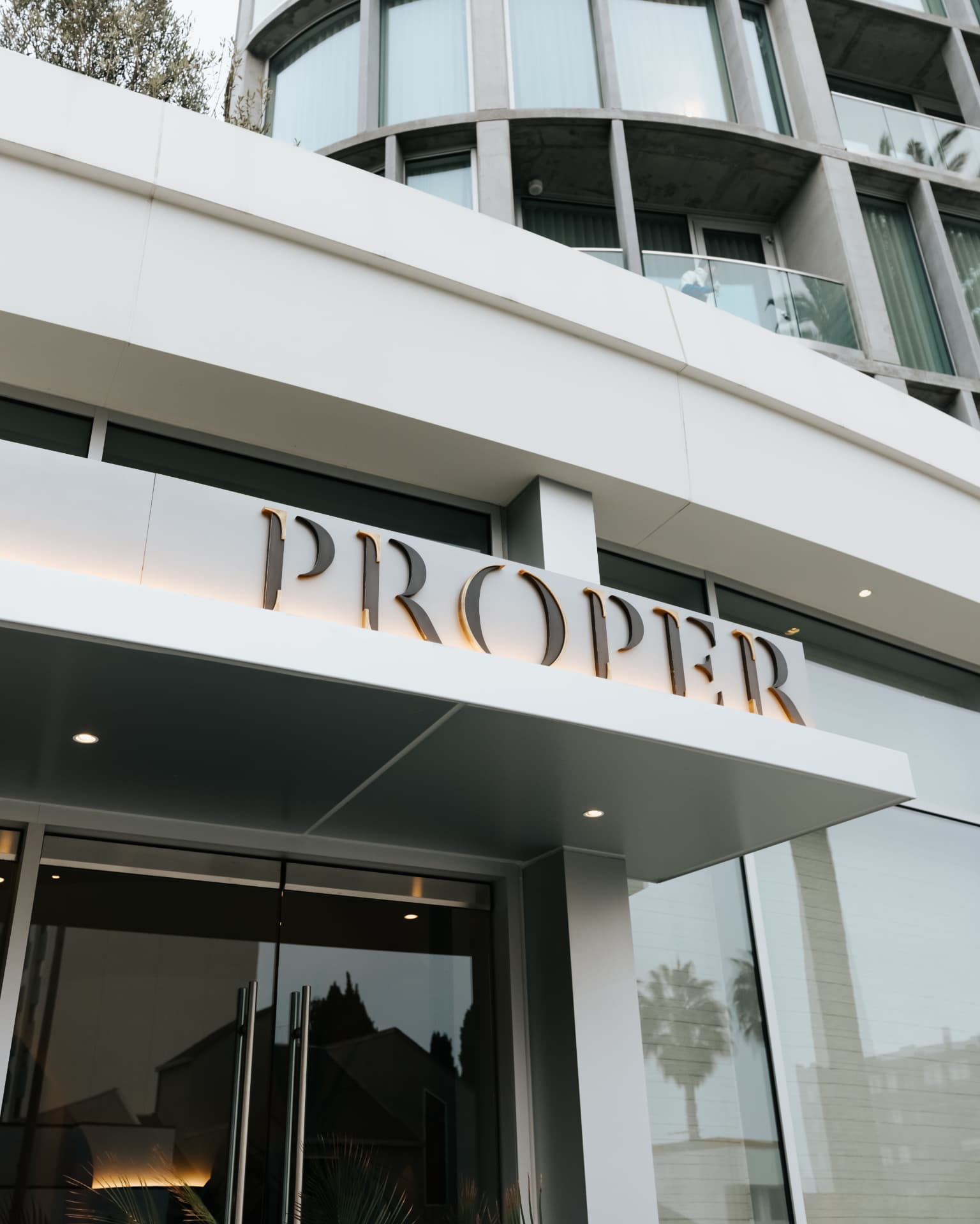 Proper Hotel entrance signage at dusk