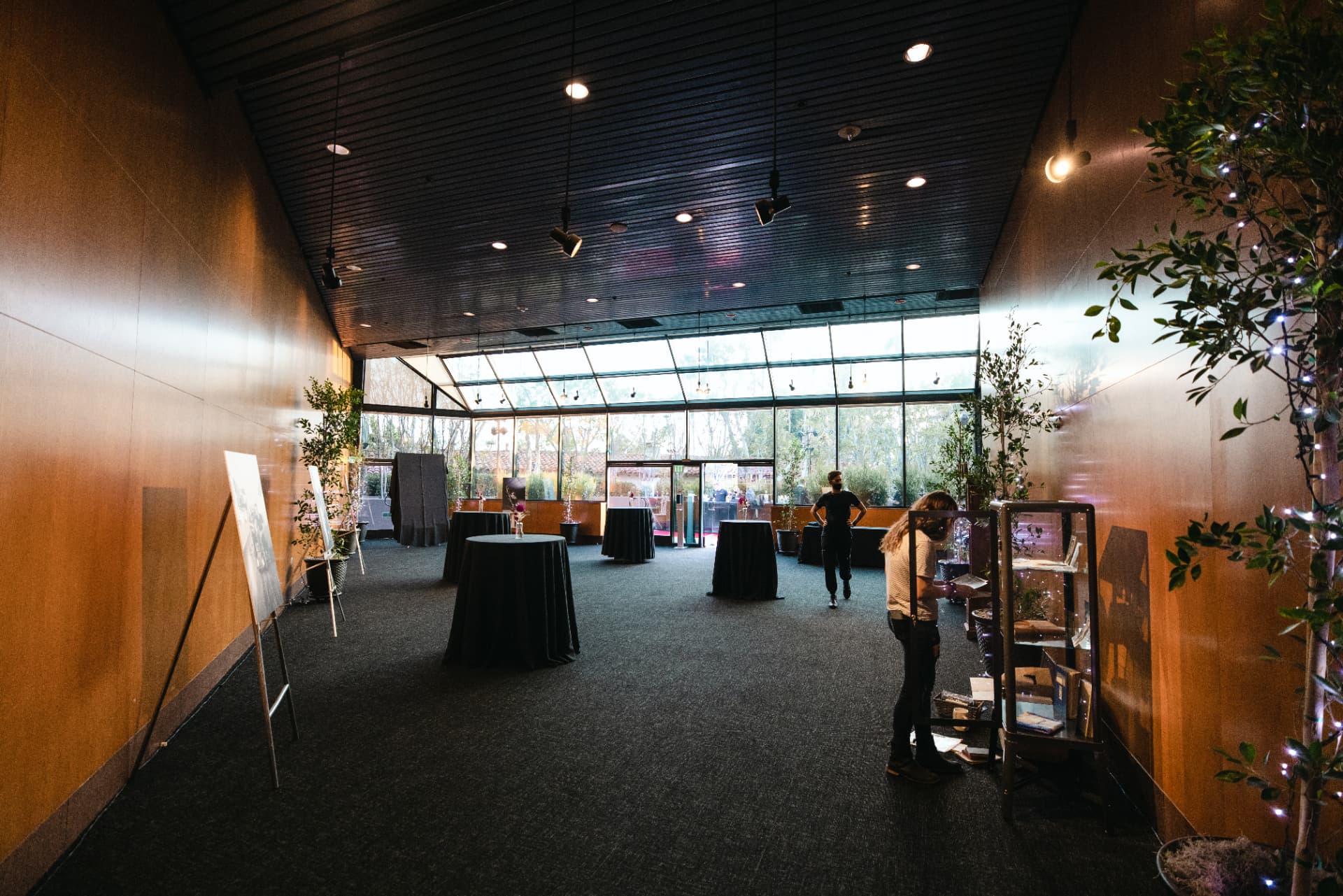 Event venue with cocktail tables and greenery