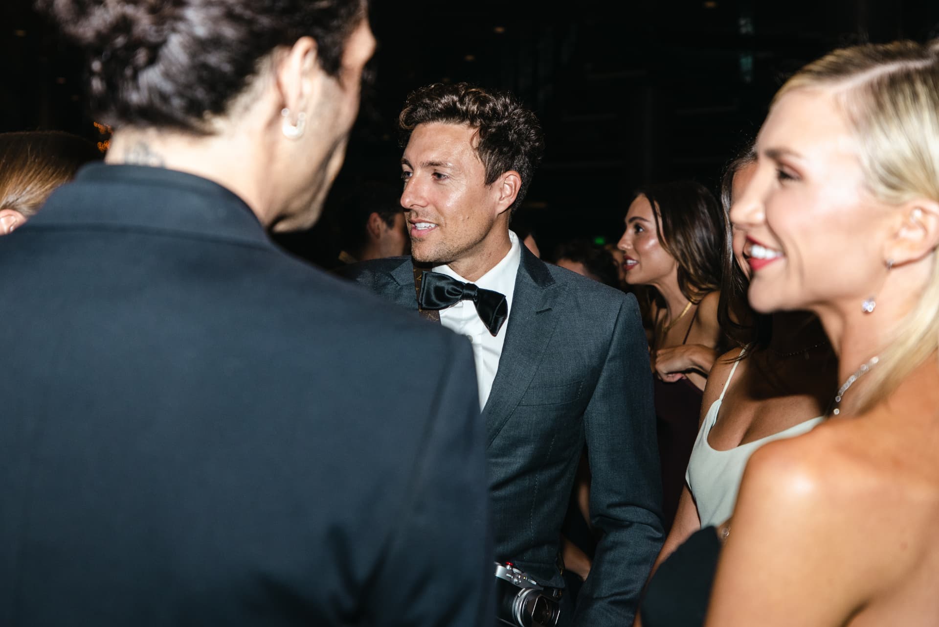 Guests mingling at a black-tie premiere afterparty