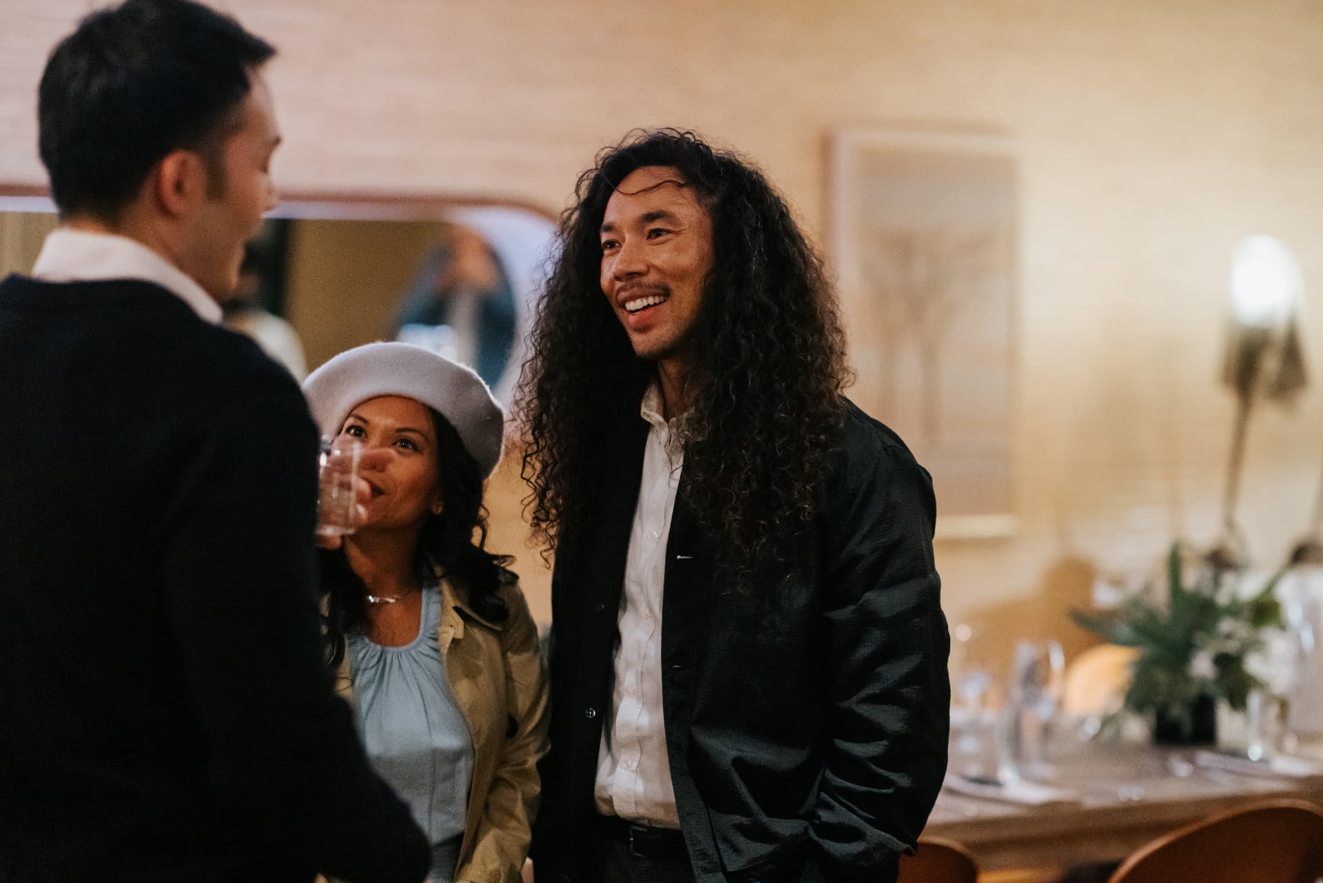 Guests laughing at a private dinner reception