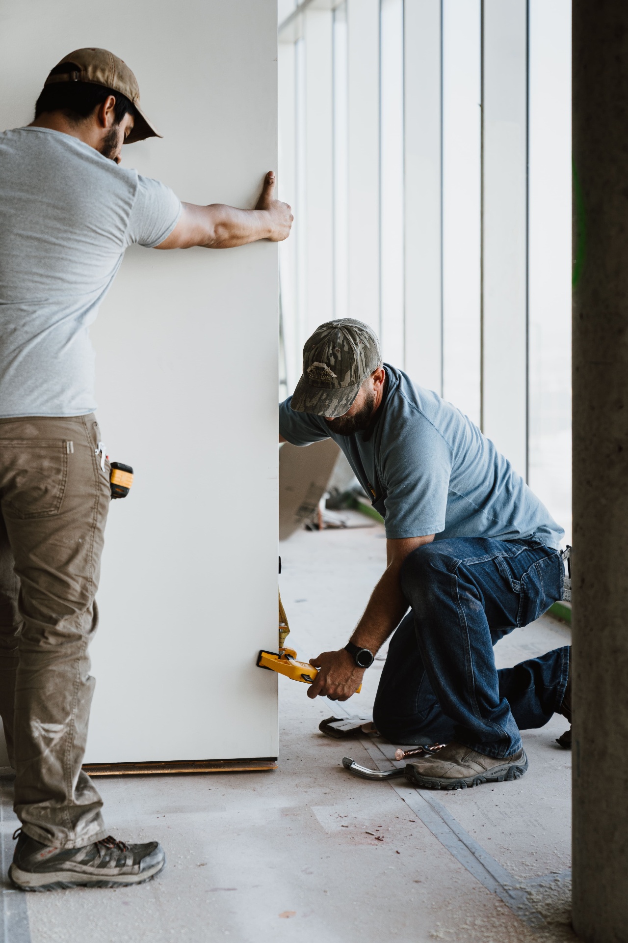 Crew installing oversized interior door