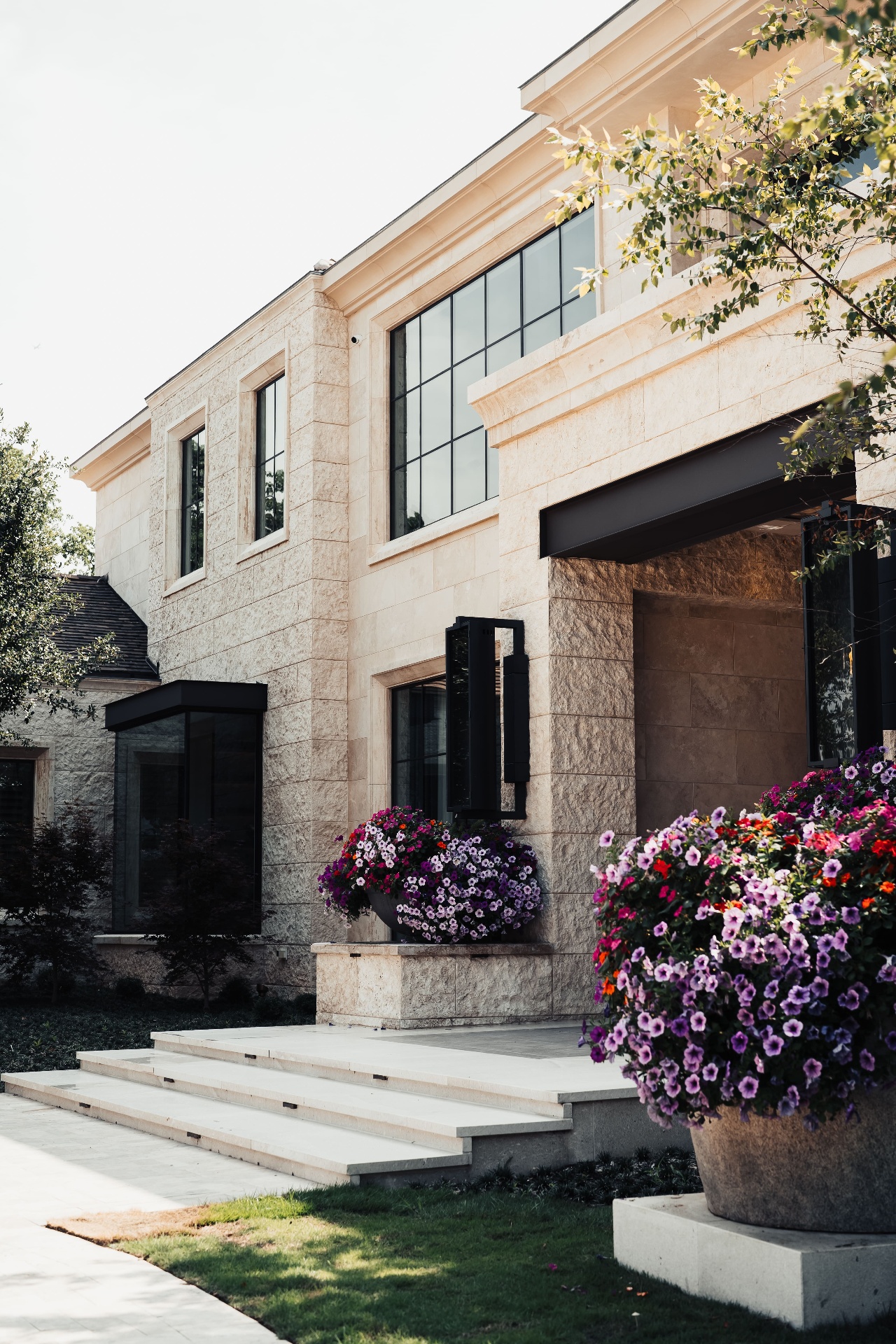 Limestone exterior with steel windows and flowers