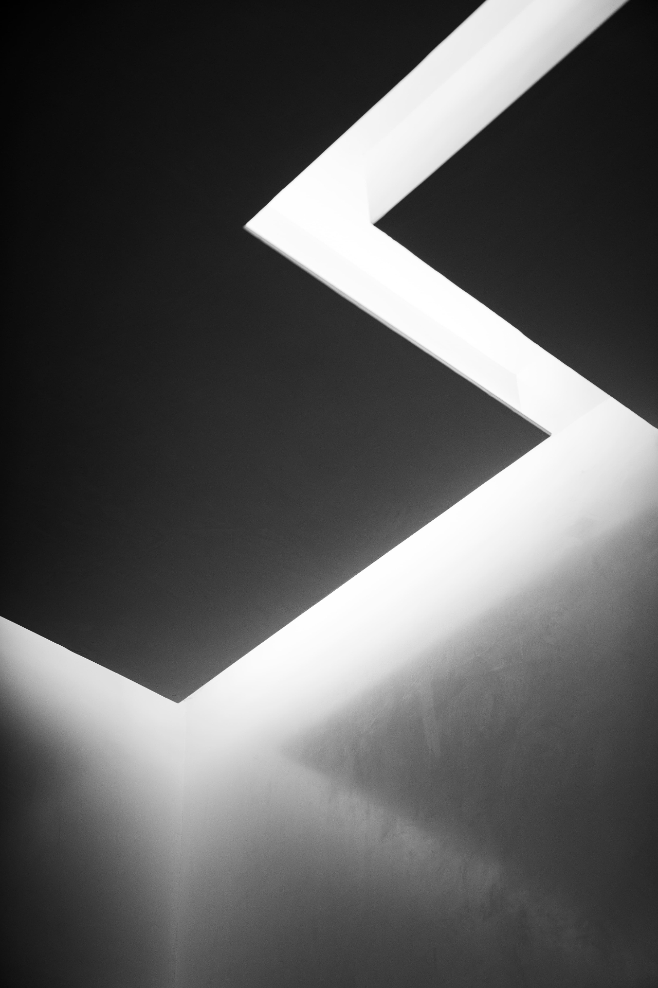 Minimal ceiling light detail in dark interior