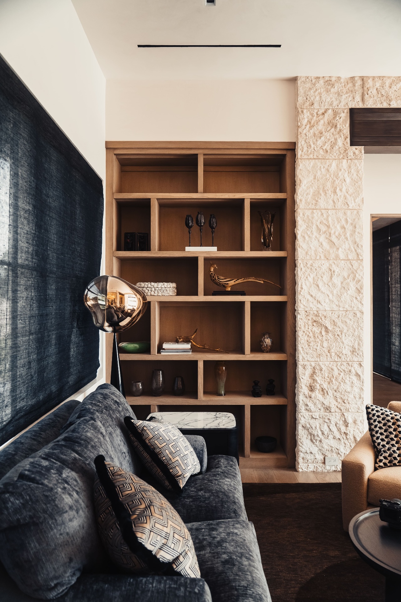 Living room with custom shelving and stone column