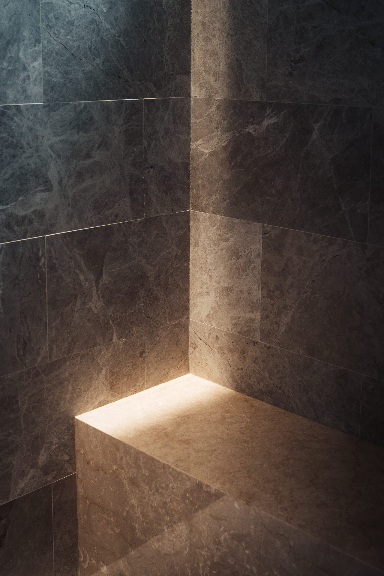Marble shower bench with ambient lighting